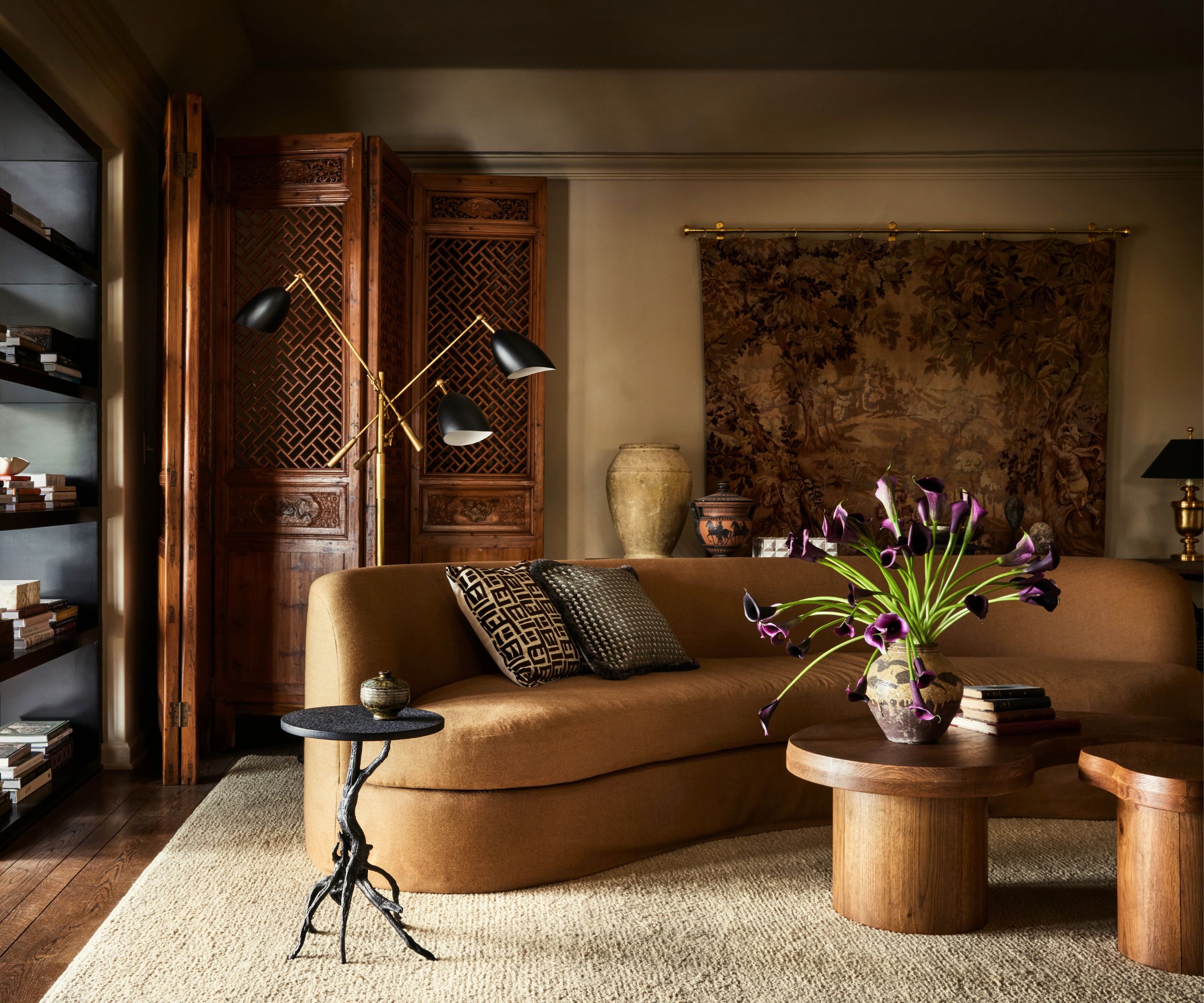 Living room design by Plaster &amp;amp; Patina painted in Riverbed by Dunn Edwards featuring a curved sofa in tan fabric