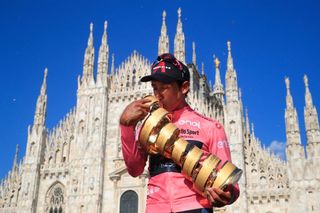 TOPSHOT Team Ineos rider Colombias Egan Bernal kisses the races Trofeo Senza Fine Endless Trophy as he celebrates on the podium after winning the Giro dItalia 2021 cycling race following the 21st and last stage on May 30 2021 in Milan Photo by Luca Bettini AFP Photo by LUCA BETTINIAFP via Getty Images