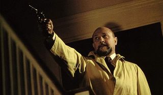 Halloween Dr. Loomis aims his gun in the house