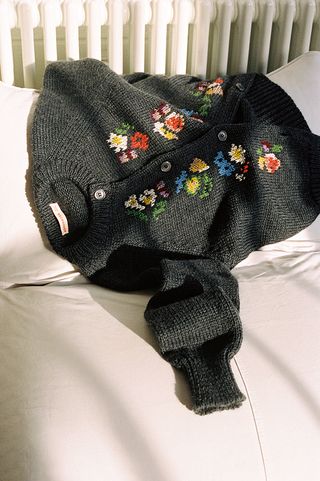 Dark knitted cardigan with flower design on front