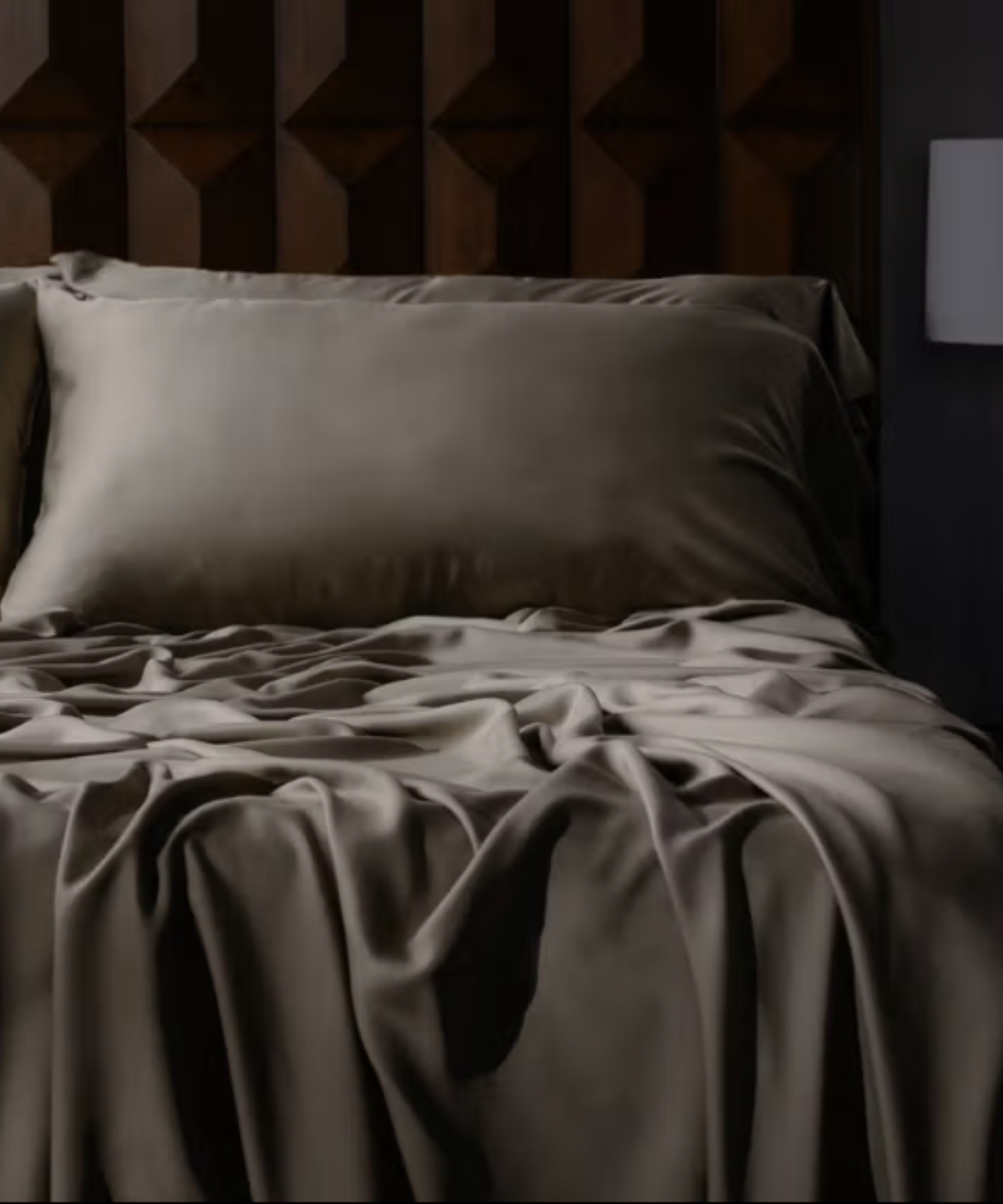Mocha brown viscose bed sheets pictured against a wooden bed frame