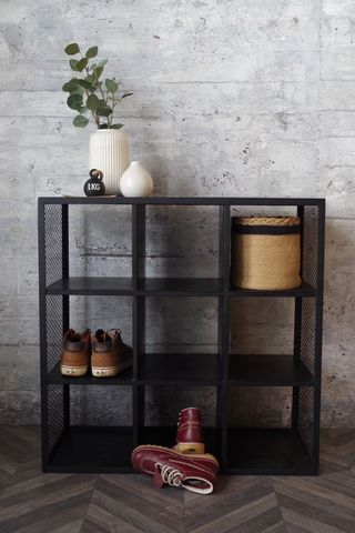 black metal cube shoe storage in a hallway