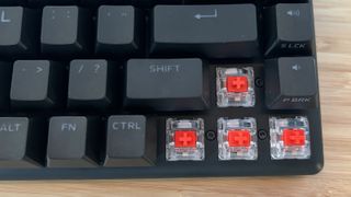 Close up on red linear switches inside Alienware Pro Wireless gaming keyboard