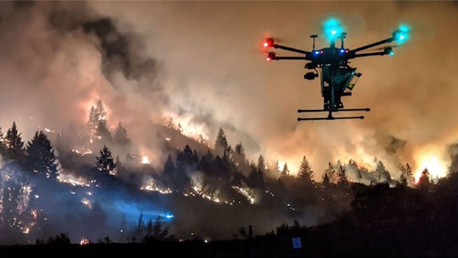 Department of the Interior Drone Conducting Aerial Ignition Operations – a hexacopter drone flying near a wildfire