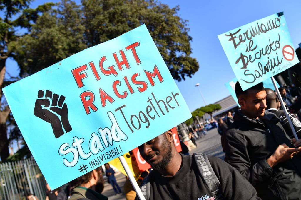 A poster reads &amp;quot;fight racism&amp;quot;