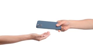 A phone being passed from one hand to another