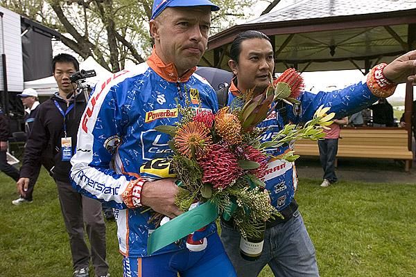 This way to anti-doping: The Le Tua team manager directs stage winner Jaan Kirsipuu to the ASADA van after the presentations.