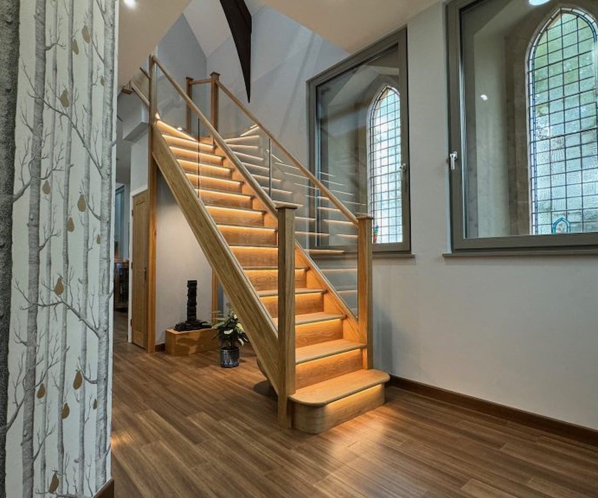A timber staircase with lights under the steps