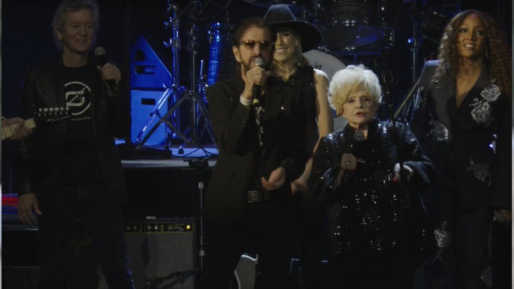 Still from the sneak peek trailer of Ring &amp; Friends showing the ex-beatles singer on stage at the Ryman