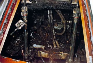 The interior of the Command Module shows the effects of the intense heat of the flash fire which killed the prime crew during a routine training exercise. A faulty electrical switch ignited the pure oxygen environment. The speed and intensity of the fire
