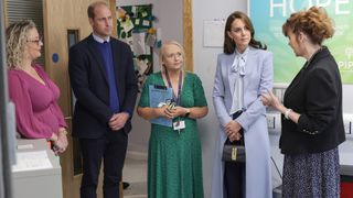 Prince William, Prince of Wales (second left) and Catherine, Princess of Wales (second right) speak with staff and counsellors during their visit to the PIPS charity