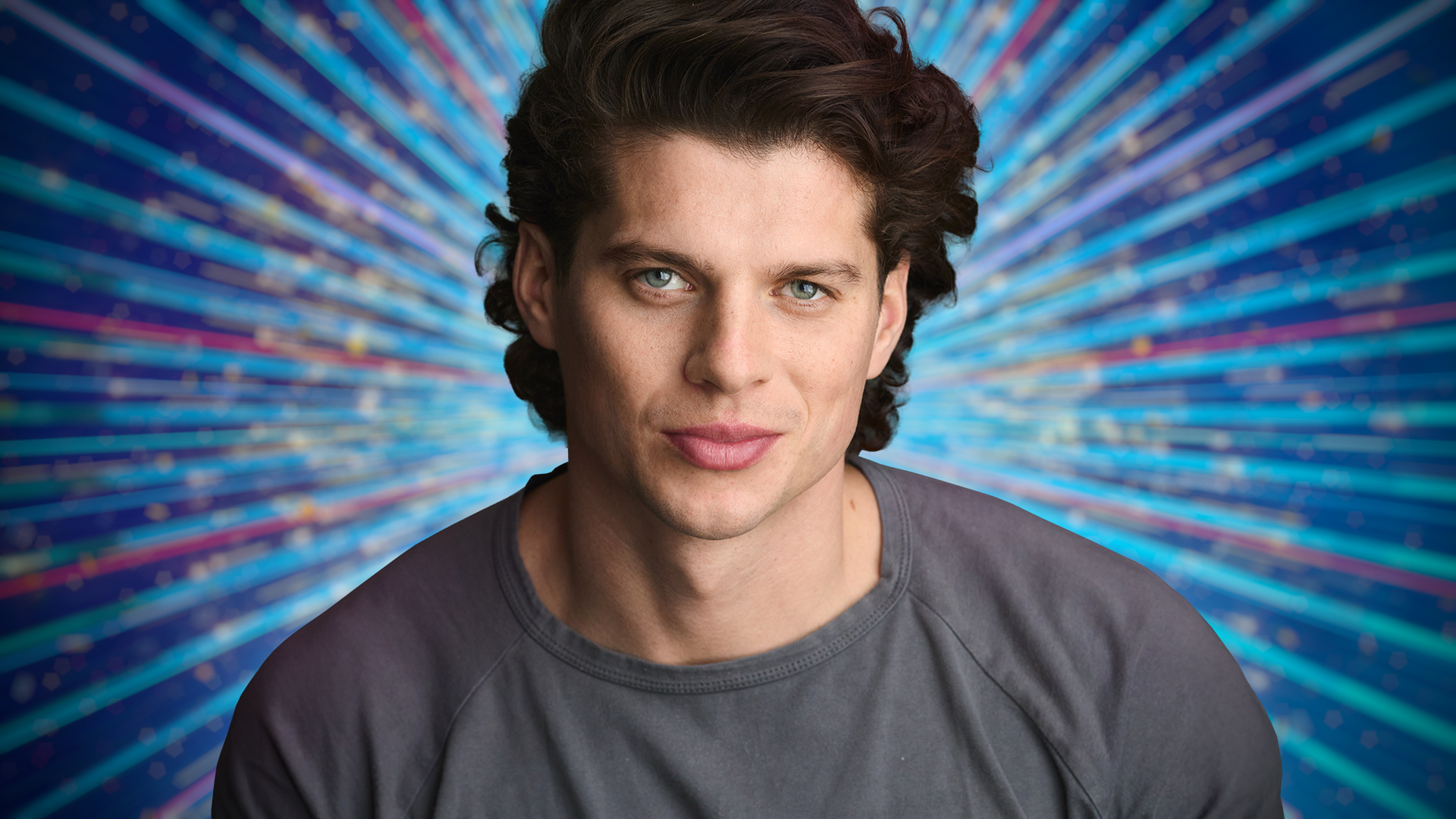 Lewis Cope headshot with sparkly blue background behind him