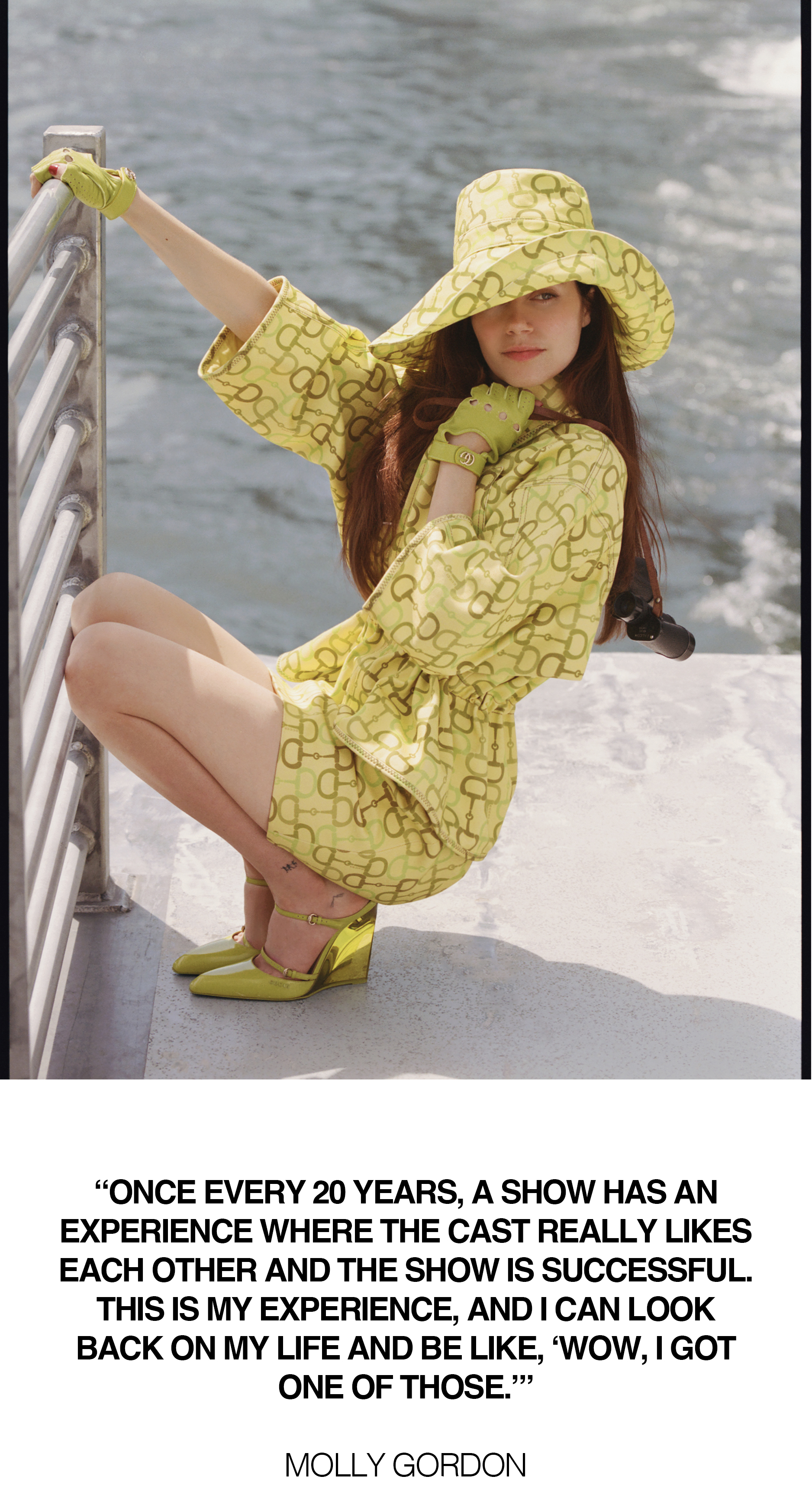 Molly Gordon on a ferry boat. She is kneeling down holding onto a railing wearing a matching yellow Gucci set comprised of a hat, jacket, skirt, and mules. Below the image is a pull quote from Gordon that says, "Once every 20 years, a show has an experience where the cast really likes each other and the show is successful. This is my experience, and I can look back on my life and be like, 'Wow, I got one of those.'"