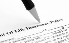 Pen being placed onto a life insurance policy. 