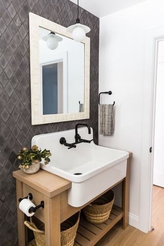 bathroom with gray tiled splash back, white basin on wooden vanity