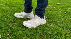 Man wearing the HOKA Transport on wet grass