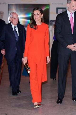 Queen Letizia wearing a bright orange co-ord