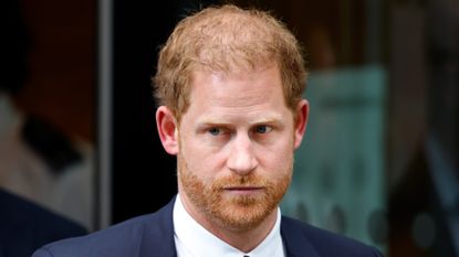 Prince Harry grimaces as he leaves a U.K. courtroom