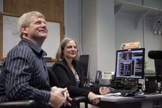NASA's New Horizon Pluto flyby mission operations manager Alice Bowman and operations team Karl Whittenburg watch screens for signals confirming that the New Horizons probe awoke from hibernation on Dec. 6, 2014. The New Horizons mission is managed from the Johns Hopkins Applied Physics Laboratory in Laurel, Maryland.