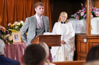 Jay Brown does a speech at Lola's funeral.