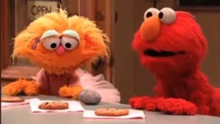 Zoe, Rocco and Elmo eating cookies on Sesame Street.