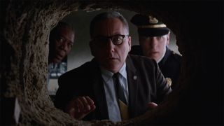 Andy's hole looked at by Warden Red and Hadley in The Shawshank Redemption