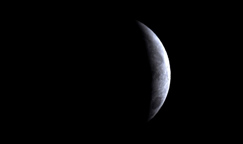 A white crescent moon during the partial lunar eclipse on Aug. 28, as imaged by the ZWO Seestar S50 Pro.