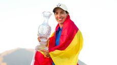 Carlota Ciganda wrapped in a Spanish flag holding the Solheim Cup