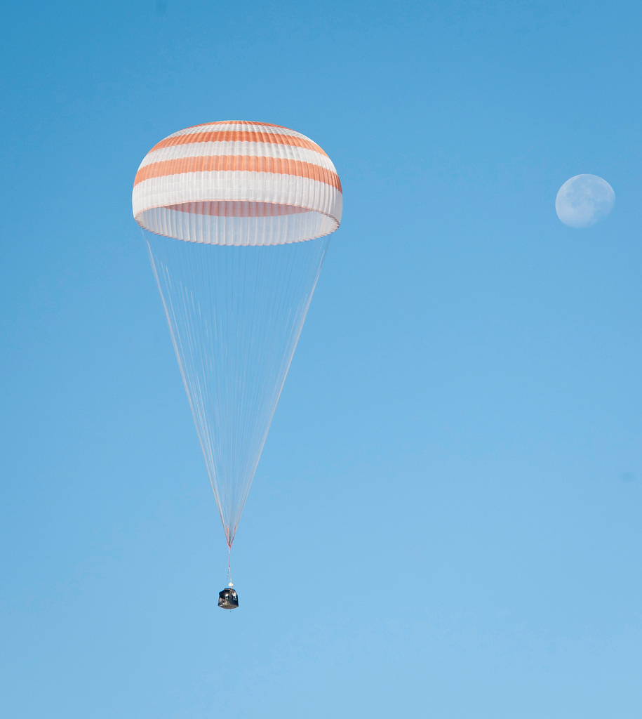 The Soyuz TMA-21 spacecraft is seen with the Moon in the background as it lands with Expedition 28 Commander Andrey Borisenko, and Flight Engineers Ron Garan and Alexander Samokutyaev in a remote area outside of the town of Zhezkazgan, Kazakhstan, on Frid