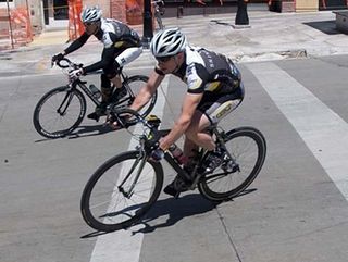 Steven Perry, Capo Clothing contest winner, races in the the Capital Square of the Willy Street Criterium in 2009.