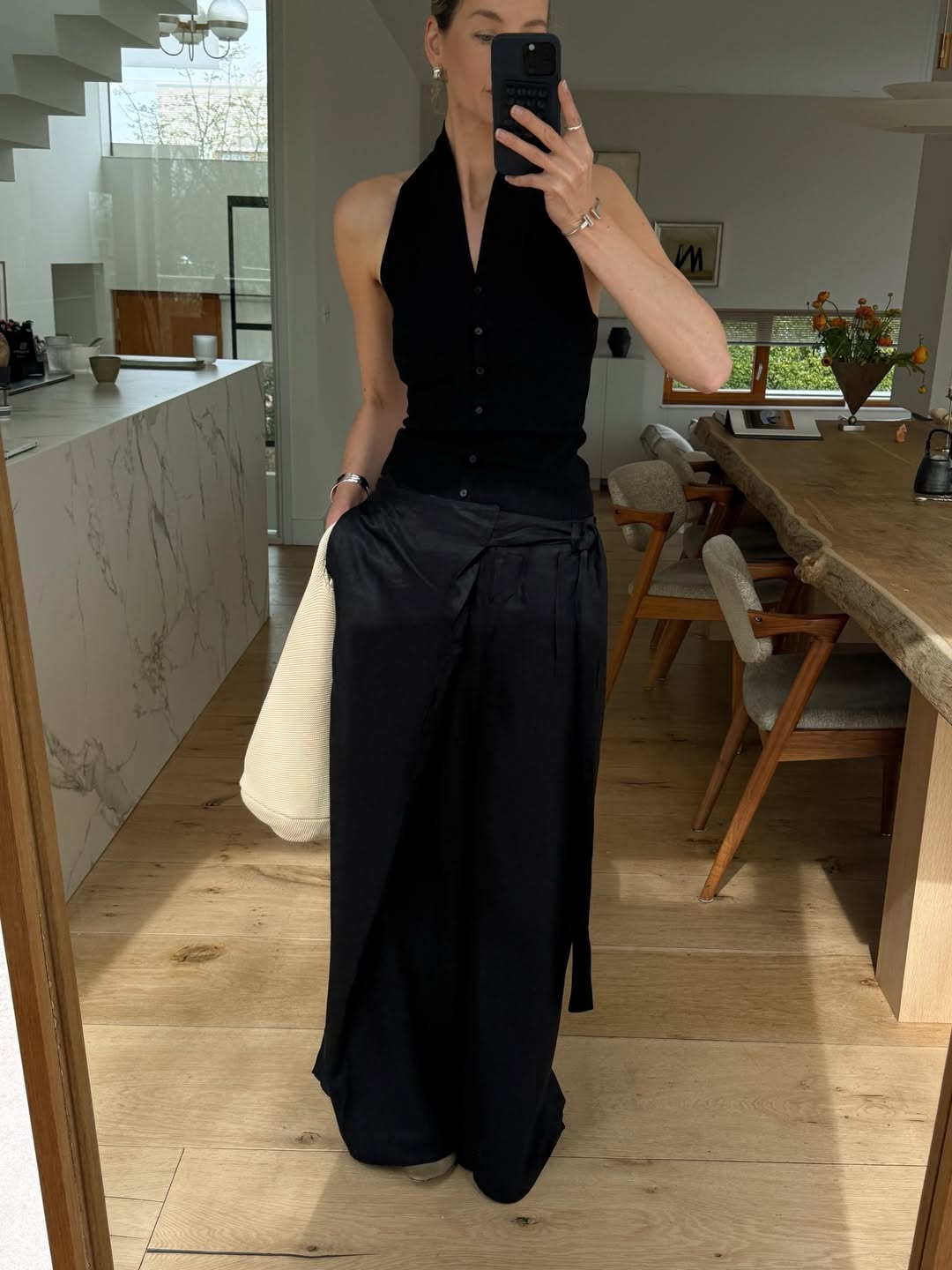 Anouk in silk black trousers and halter-neck top