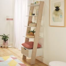 white wall with wooden flooring and ladder with shelving unit