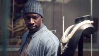 Omar Sy (as the character Luis Perenna) eyes the Queen's Necklace in the Netflix series "Lupin."