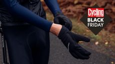 Image shows a rider pulling on a pair of cycling gloves.