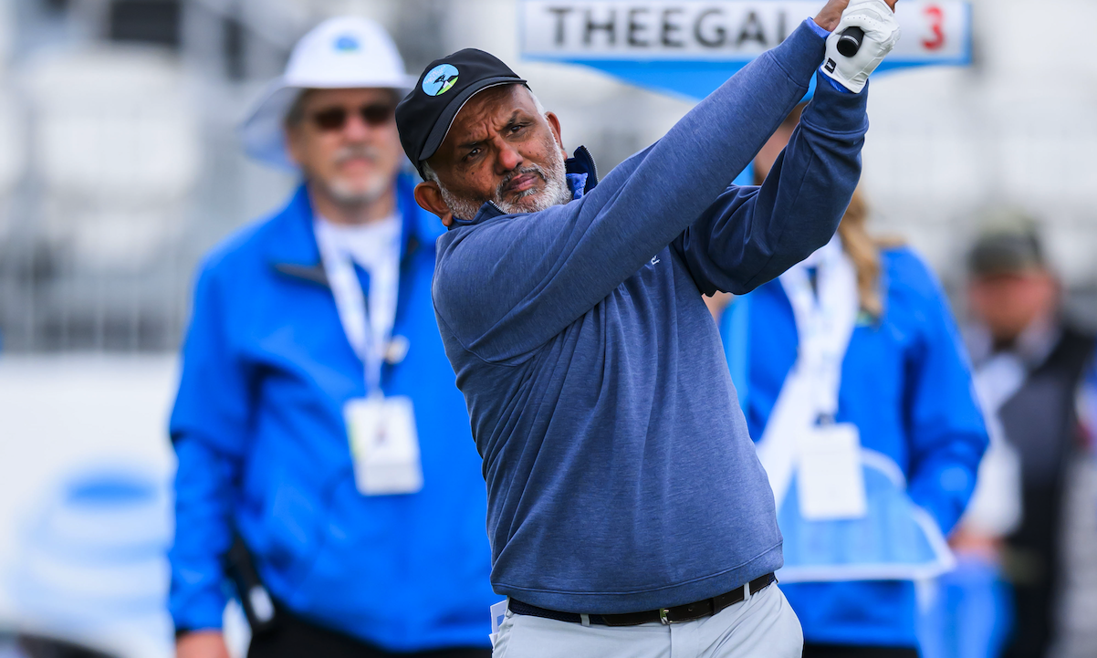 Shantanu Narayen holds his finish on a tee shot