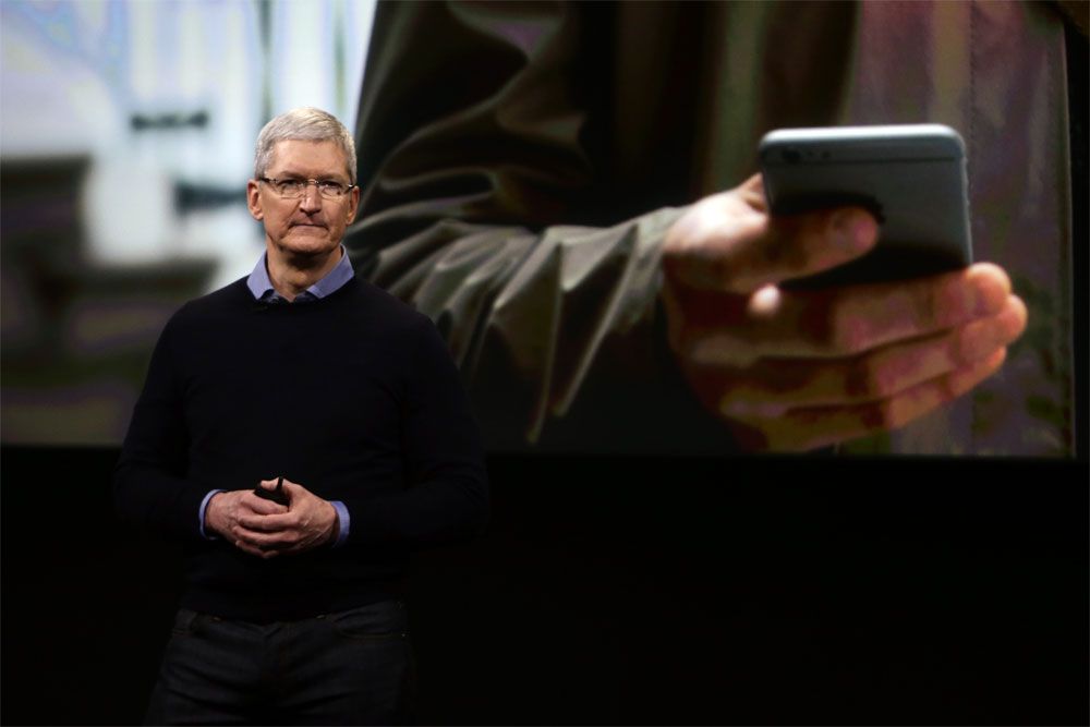 Apple CEO Tim Cook presenting an iPhone.