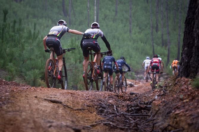 Christoph Sauser gives team mate Frantisek Rabon of Meerendal Songo Specialized a helping hand