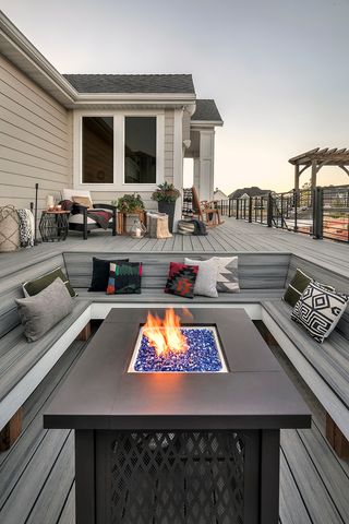 A table firepit with a sunken outdoor sofas