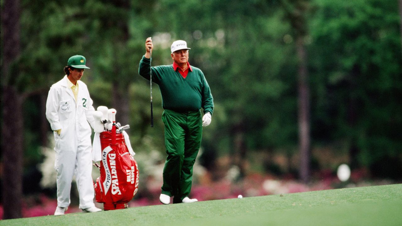 Billy Casper walks to the green with his caddie during the 1989 Masters Tournament at Augusta National Golf Club