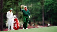 Billy Casper walks to the green with his caddie during the 1989 Masters Tournament at Augusta National Golf Club