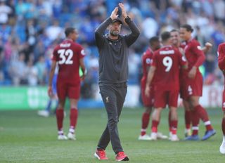 Liverpool manager Jurgen Klopp, centre, acknowledges the fans after a vital win at Cardiff