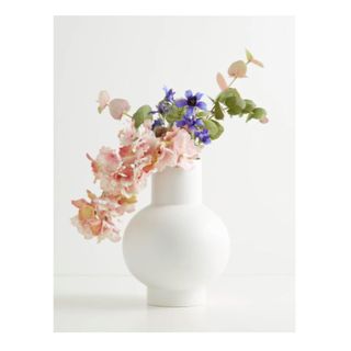 white rounded vase with cylindrical neck and flowers