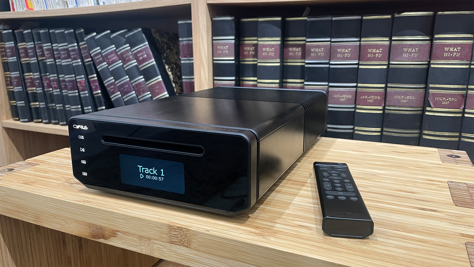 Cyrus 40 CD CD player in black on a wooden surface with a remote