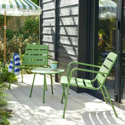 Habitat Annika 2 Seater Metal Garden Bistro Set in green on a patio