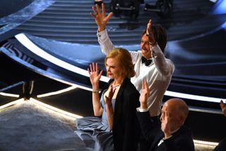 US actor J.K. Simmons (R), US-Australian actress Nicole Kidman (C) and Australian-US musician Keith Urban (L) applaud the Best Picture award for "CODA" during the 94th Oscars at the Dolby Theatre in Hollywood, California on March 27, 2022.