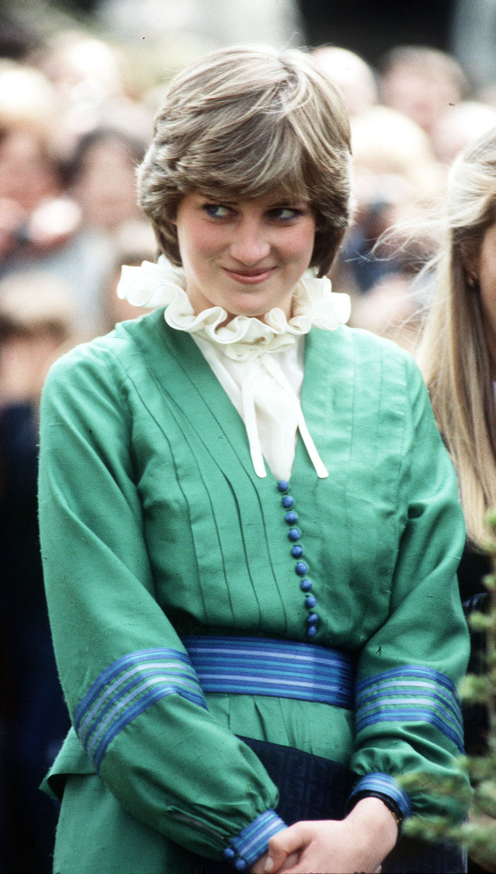 Princess Diana wearing a green top and white blouse