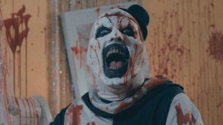 Screenshot of Art the Clown splattered with blood in bedroom in Terrifier 2