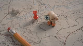 Marcel the Shell with Shoes on using a map