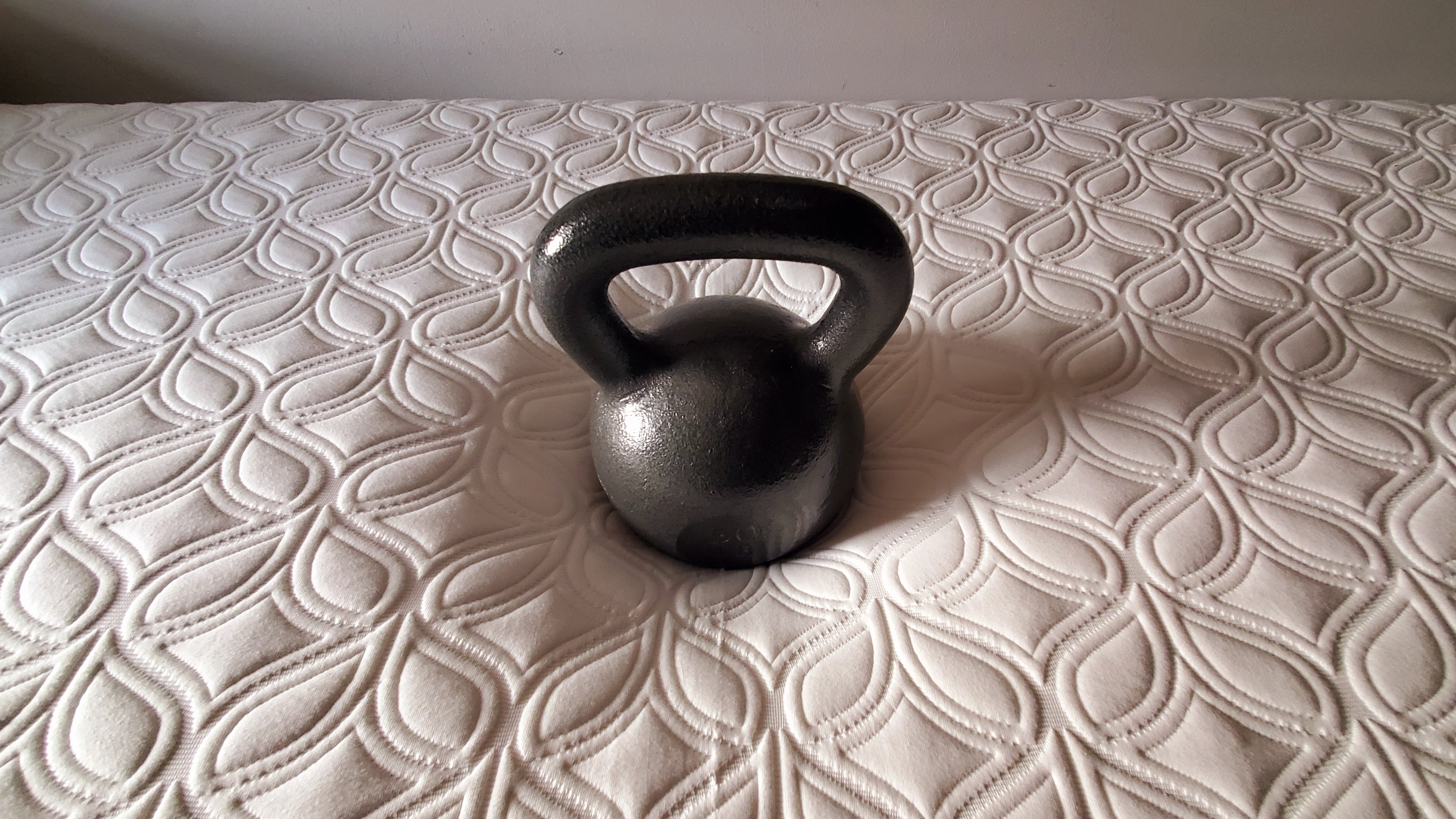 Cocoon by Sealy Chill mattress, testing pressure relief by placing a 50lb kettlebell in the middle