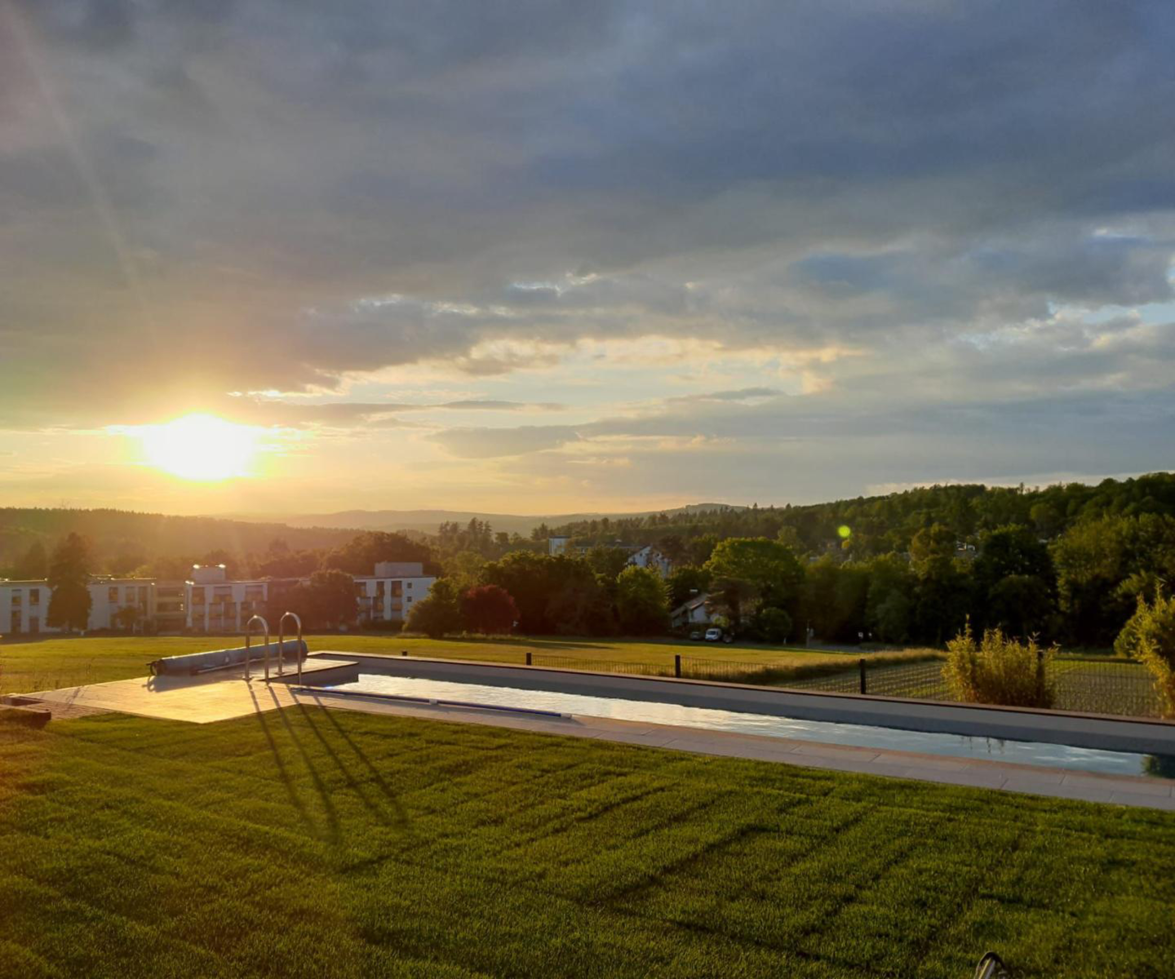 below ground pool in large garden surrounded by sweeping views and large lawns